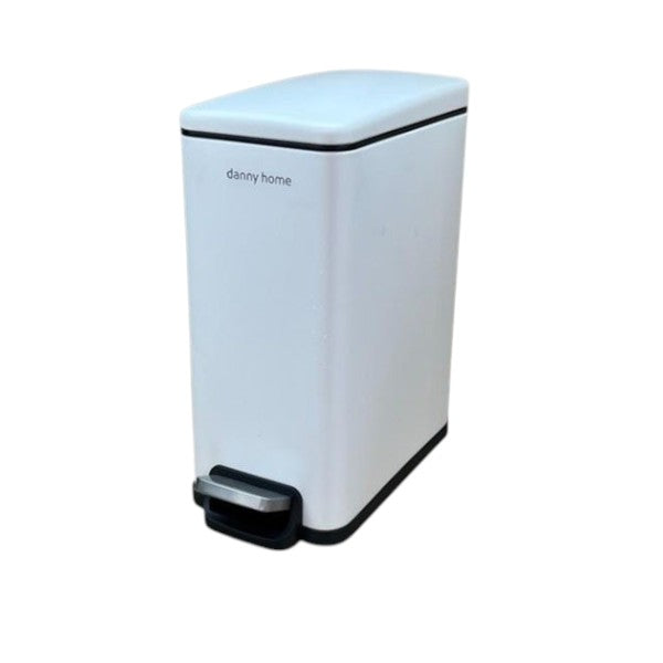 White trash bin with black accents on a wooden surface and marble wall background