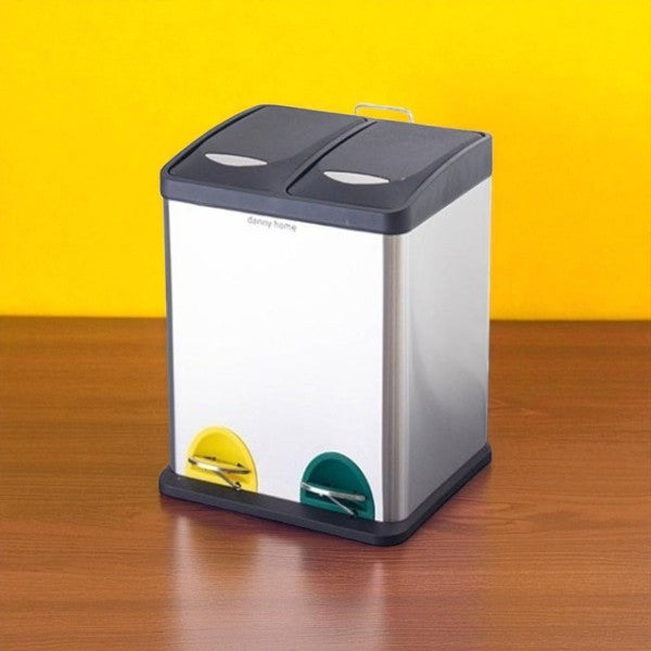 Two-compartment trash can on a wooden surface with a yellow background