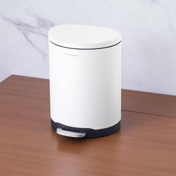 White trash bin with black base on a wooden surface