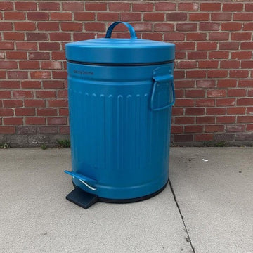 Blue trash bin with a handle and foot pedal in front.